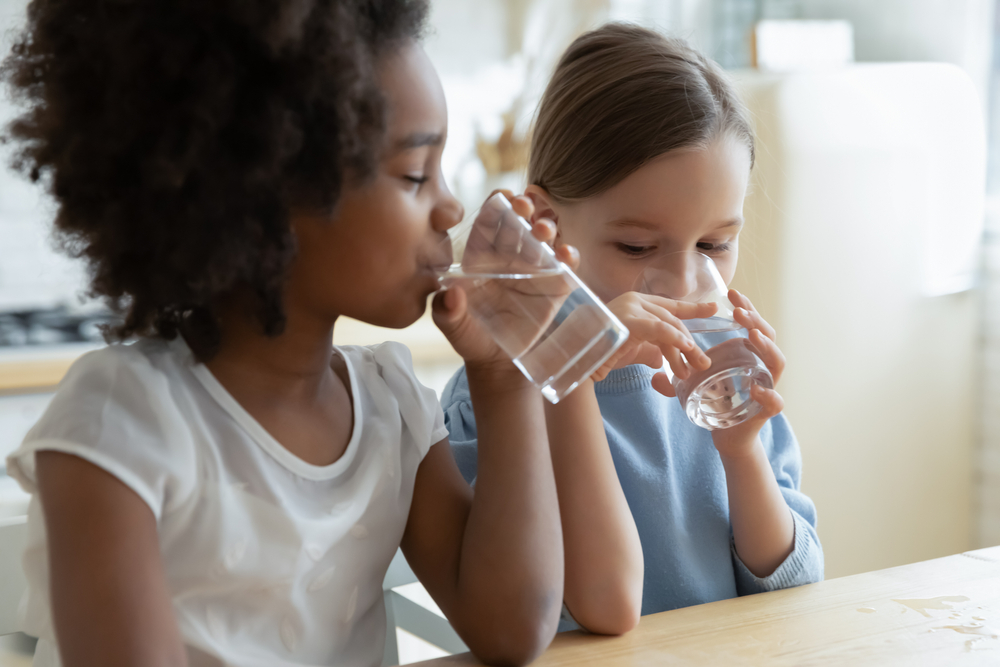 Two children drinking water
                        