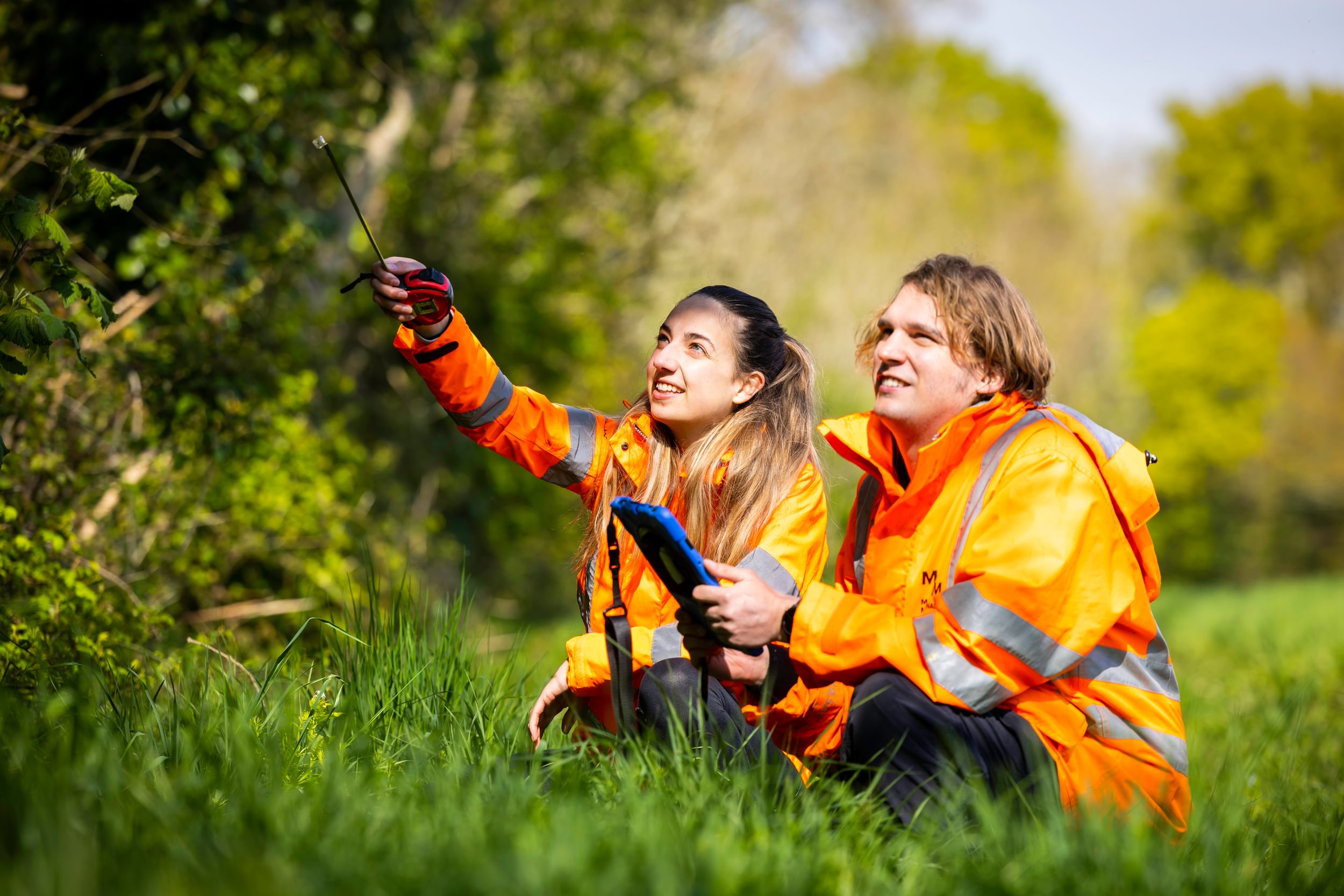 Young couple doing environmental surveying outside 