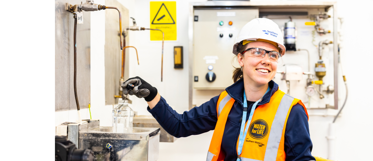 A worker testing water