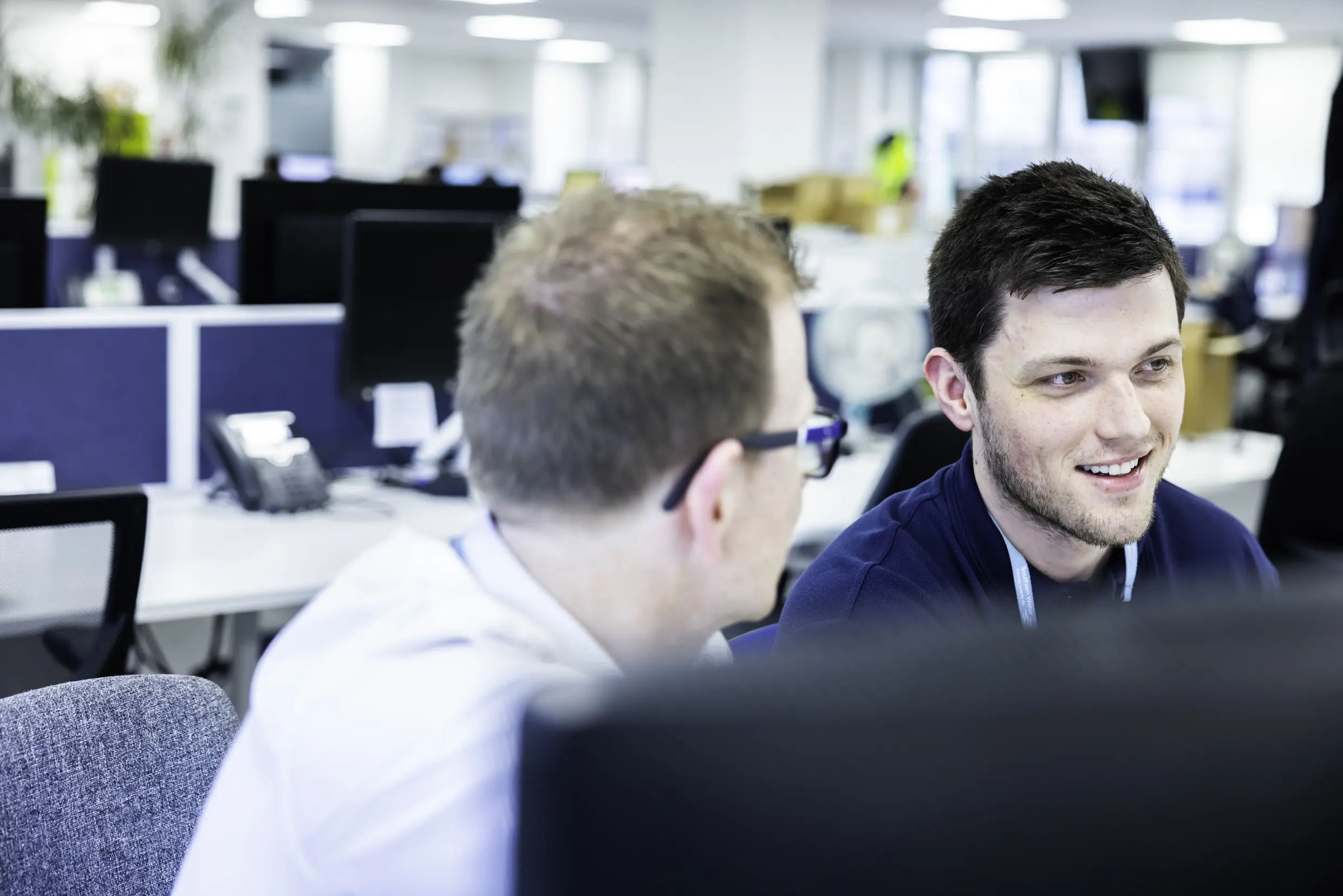 two men discussing business at a computer 