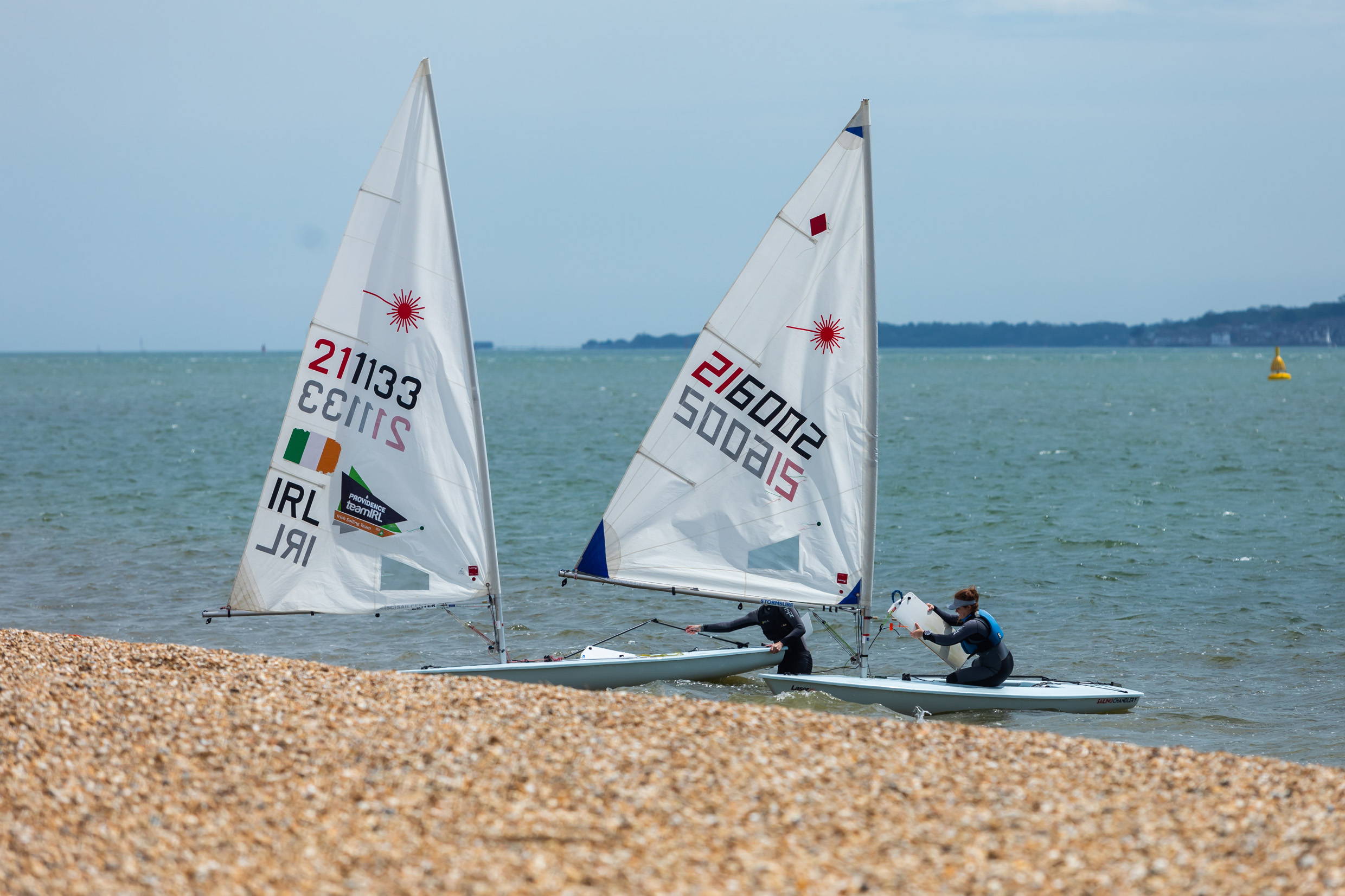 Two windsurfers at Stokes Bay Beach on a sunny day