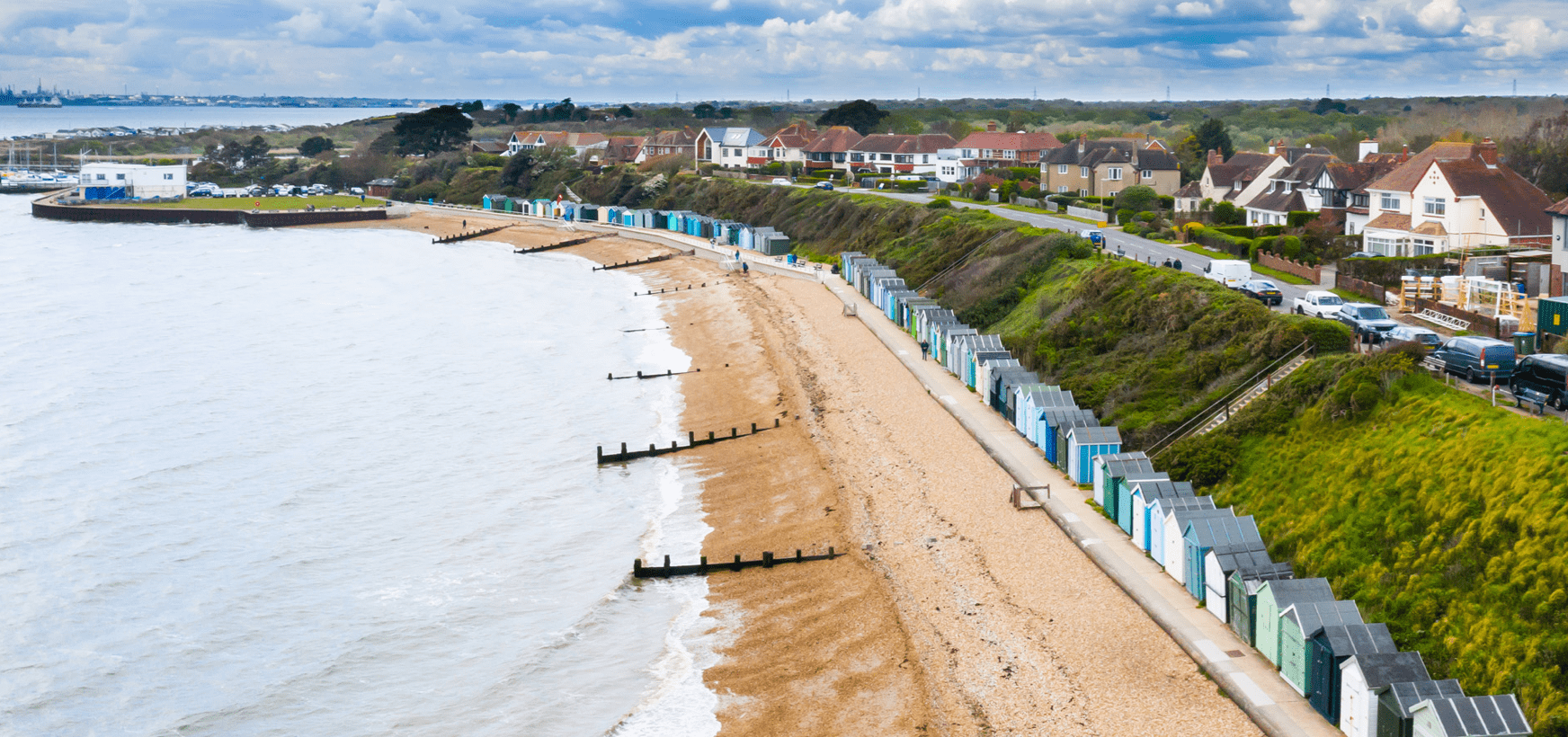 An aerial photo of Hillhead coast, its houses, beach huts and groynes