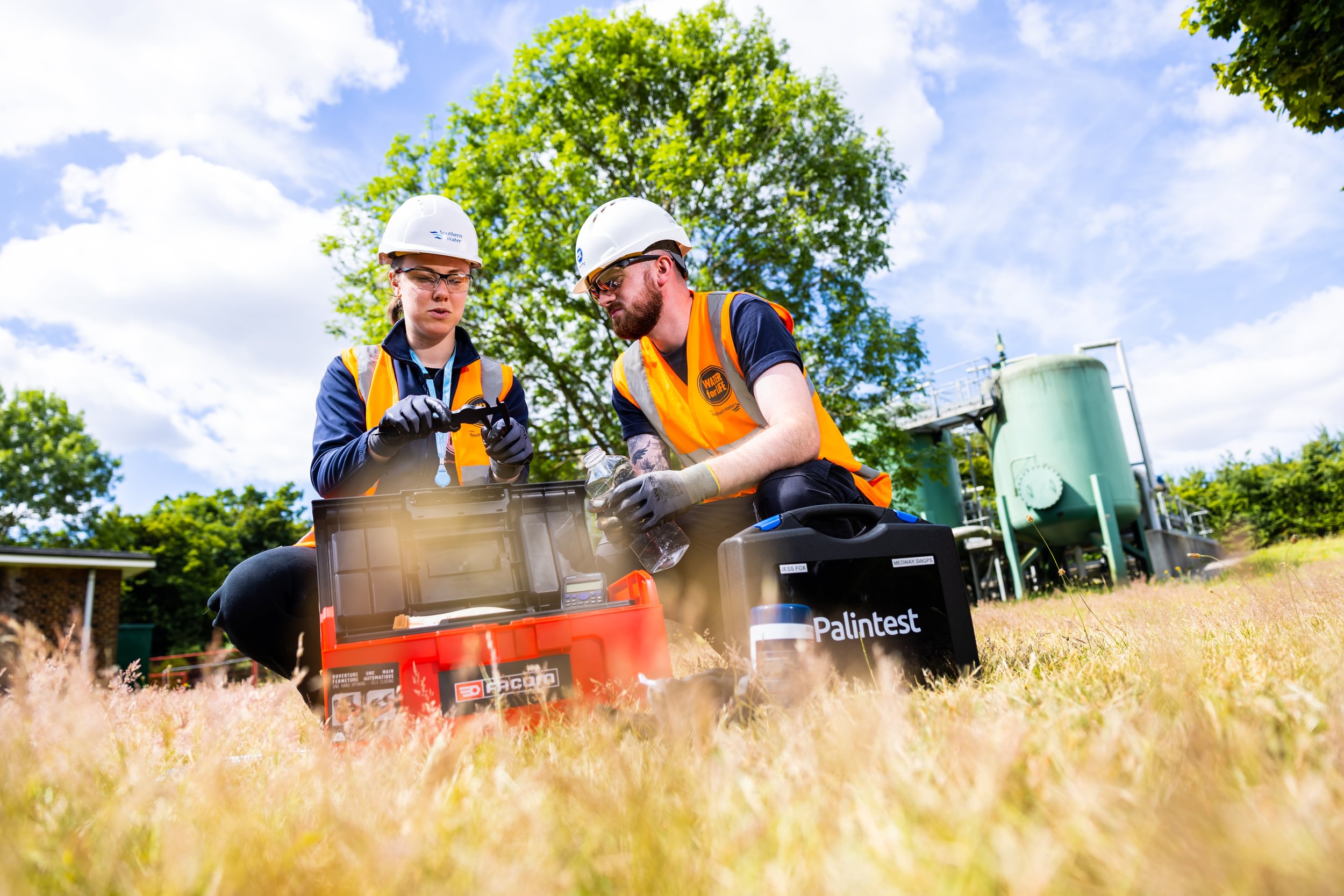 Southern Water employees working in a field 
                        