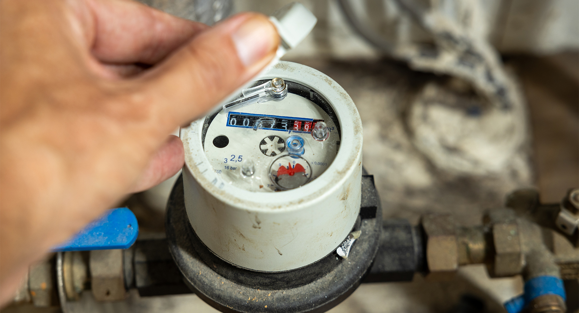 A person observing a water meter
                        