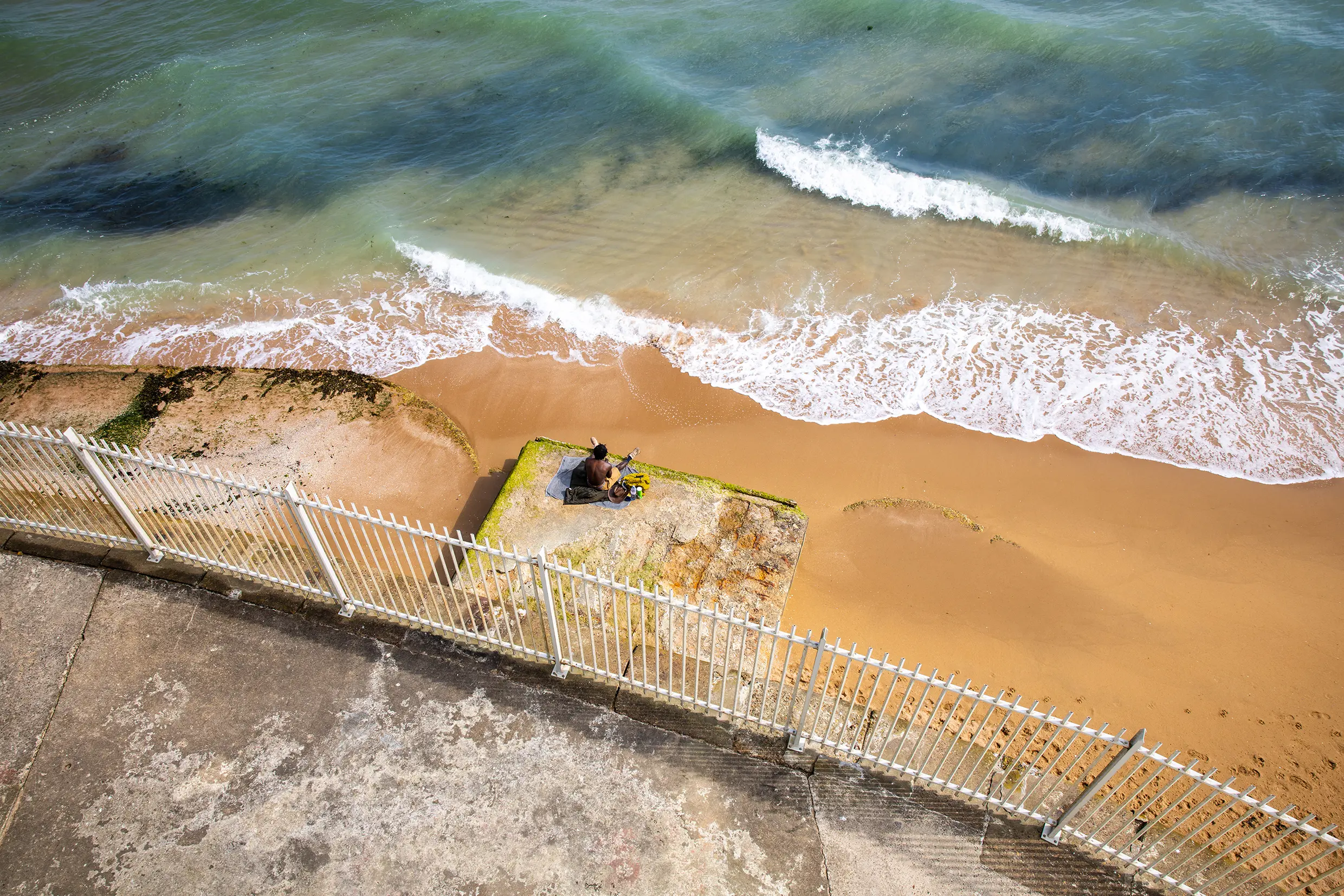 A shot of a person sitting on Margate beach