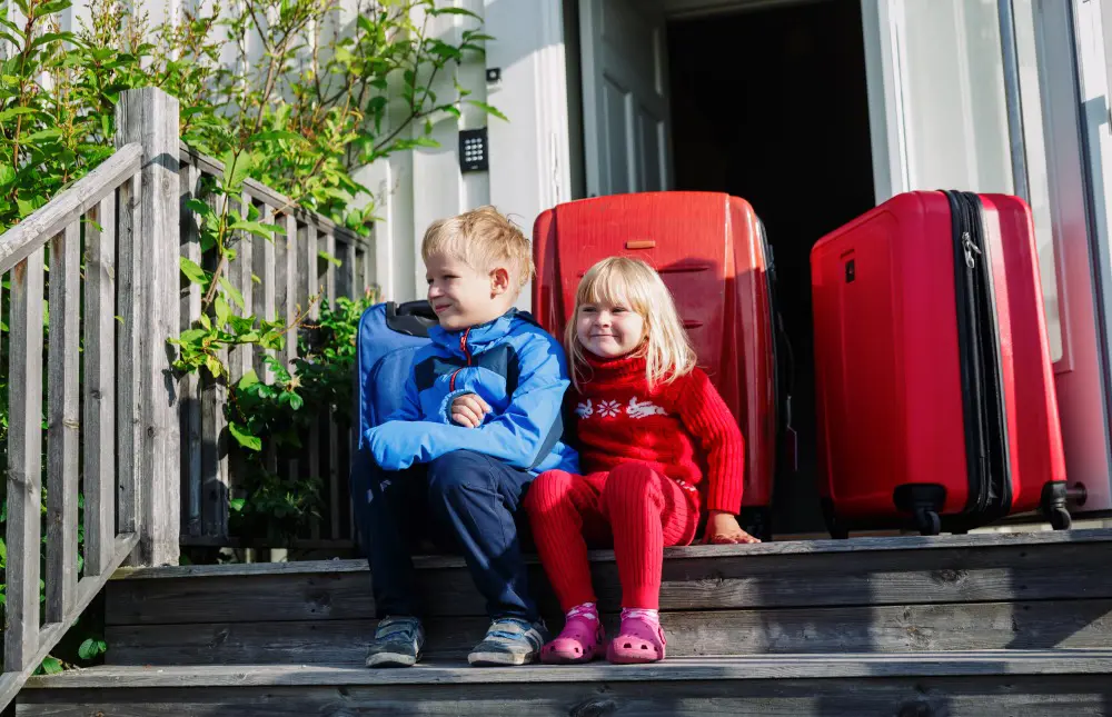 two children waiting to go on holiday